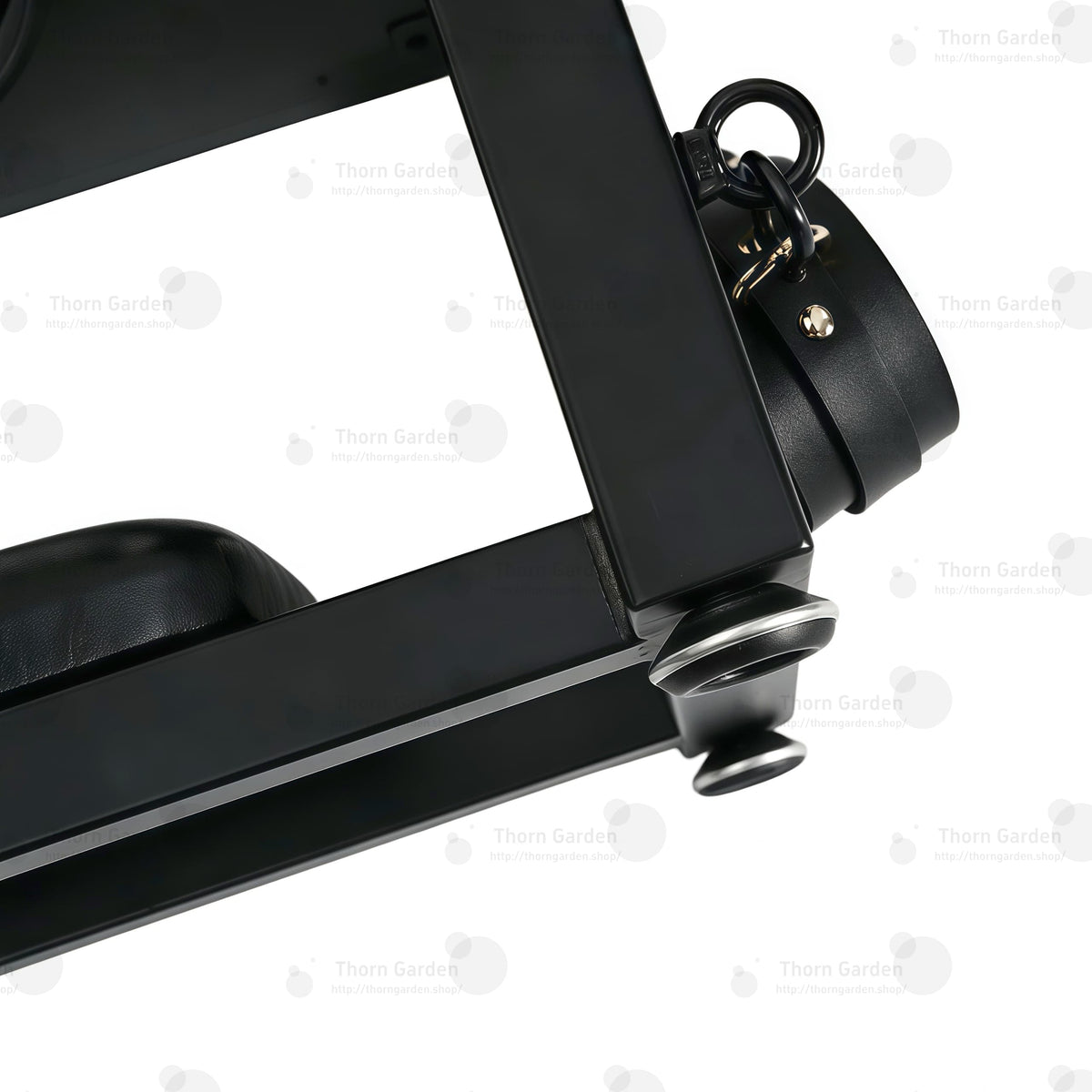 Detail of bottom padded leather headrest cushion and adjustable leveling feet on industrial steel frame