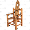 Full view of solid wood torture bondage armchair with hand-carved spiked texture, neck hole, chains, and restraints