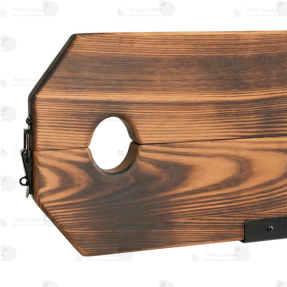 Close-up of burnt-wood finish pillory top with neck and wrist openings and integrated lock