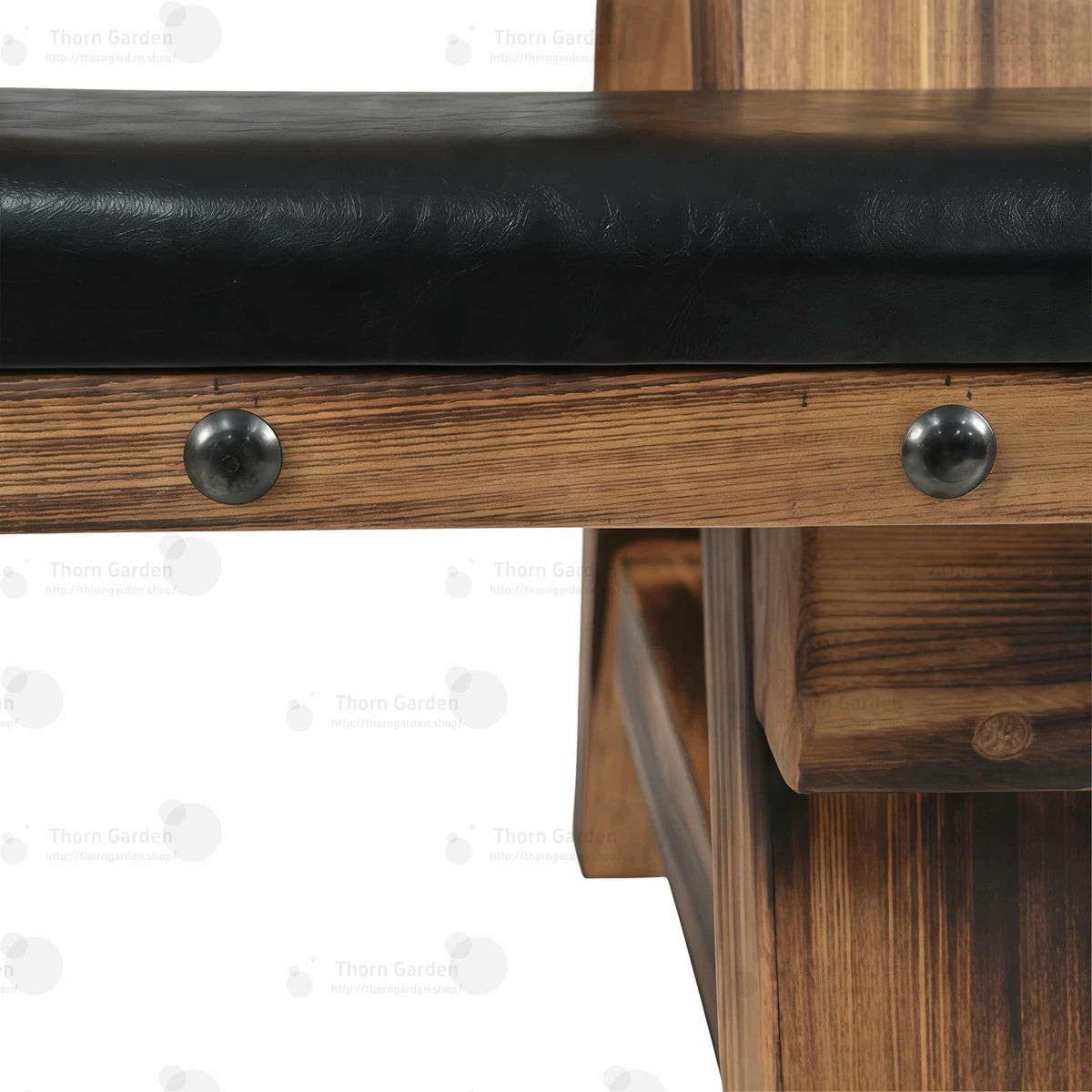 Close-up of side bench leather cushion edge showing brass rivets and black metal O-ring anchors