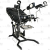 Side profile of electric gyno bondage chair with motorized height adjustment, leather padded cushions, restraint straps, and leg supports