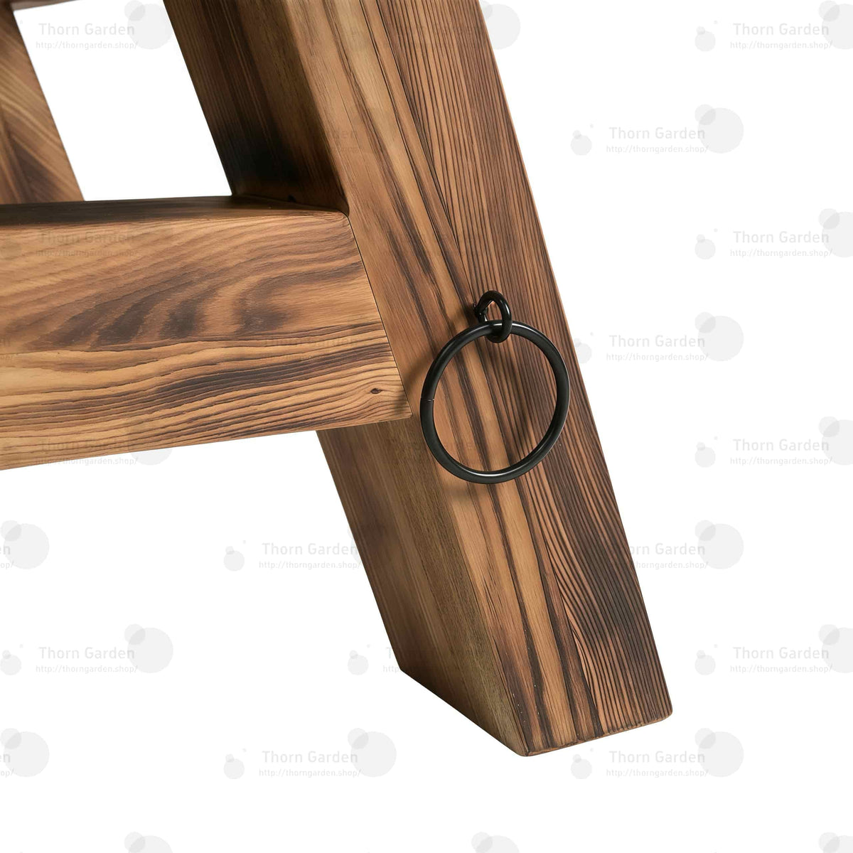 Side view of heavy-duty metal tie-down ring attached to the wooden A-frame leg for restraint straps