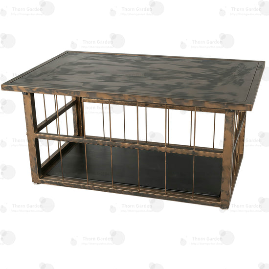 Close-up of distressed antique bronze tabletop finish and adjustable leveling feet on TG062 coffee table cage