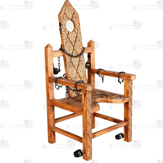 Full view of solid wood torture bondage armchair with hand-carved spiked texture, neck hole, chains, and restraints