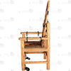 Full view of solid wood torture bondage armchair with hand-carved spiked texture, neck hole, chains, and restraints