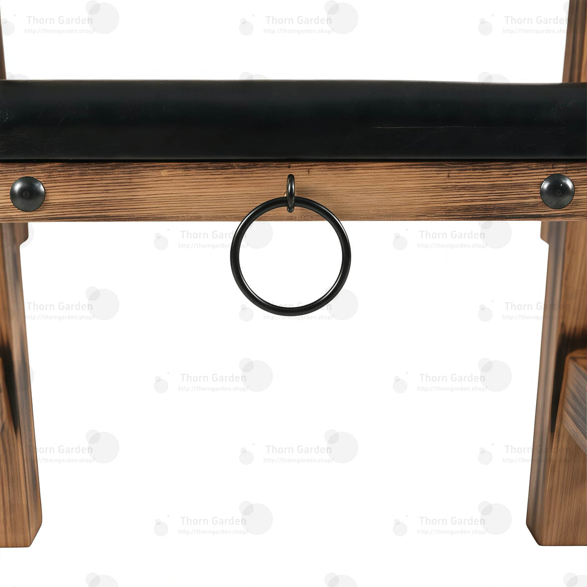 Close-up of black metal side anchor ring mounted on solid wood beam with heavy-duty rivets