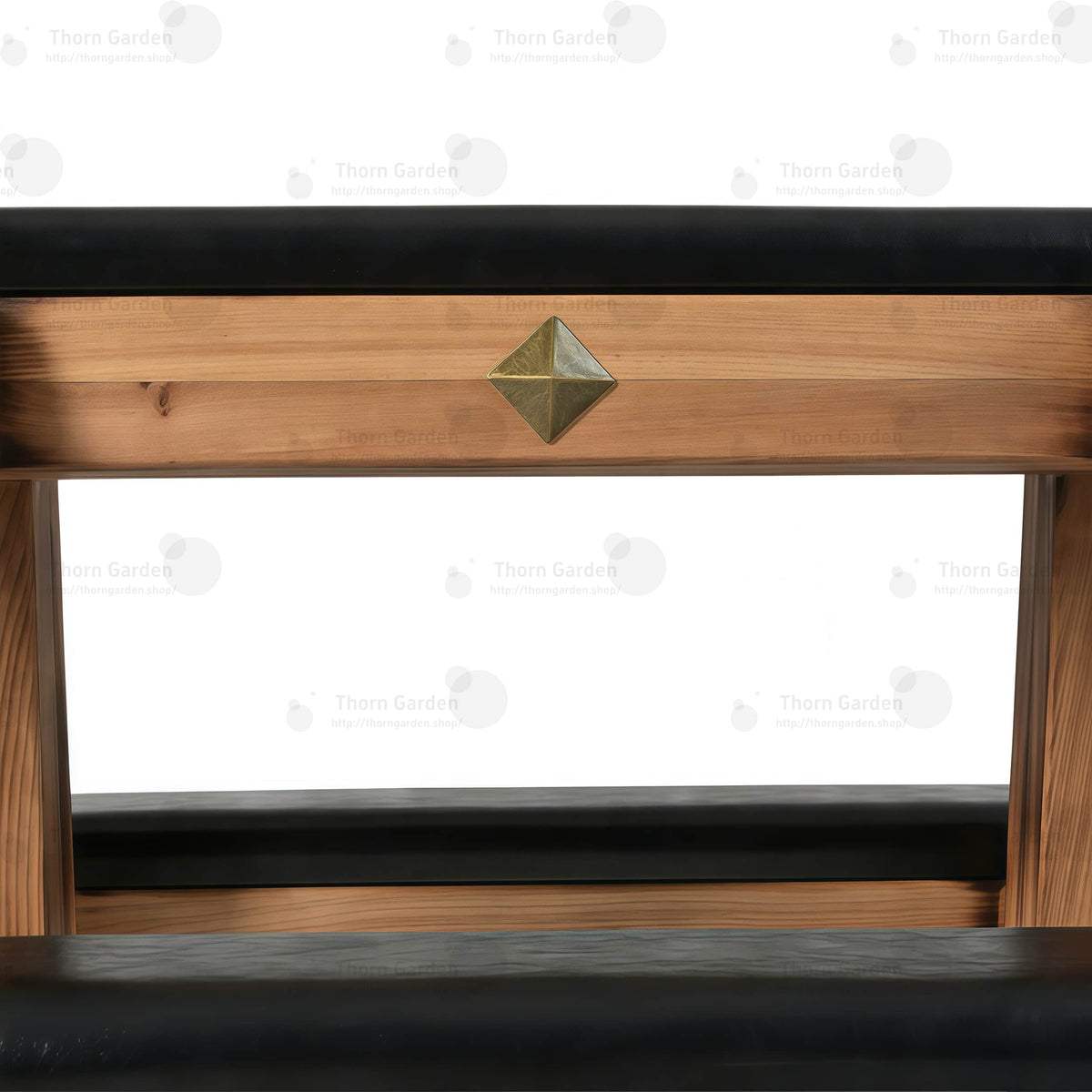 Close-up of decorative yellow brass rivets mounted along the edge of black leather padded cushion