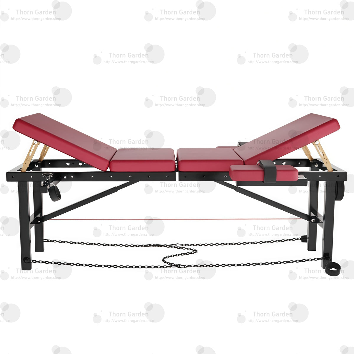 Product display detail view of the THORN GARDEN Adjustable BDSM Bondage Bed - TGZDCPLUS highlighting the professional black steel frame, burgundy leather padded sections, gold-colored mechanical support rods, and base chain restraints